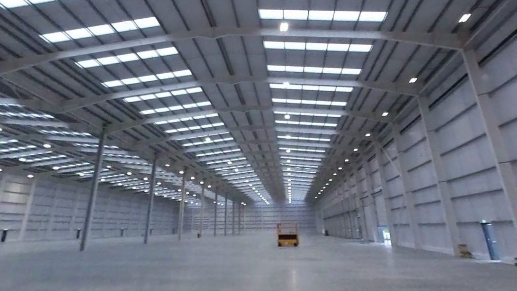 EMPTY NEW INDUSTRIAL WAREHOUSE SHOWCASING LIGHT INALLATION DESIGN