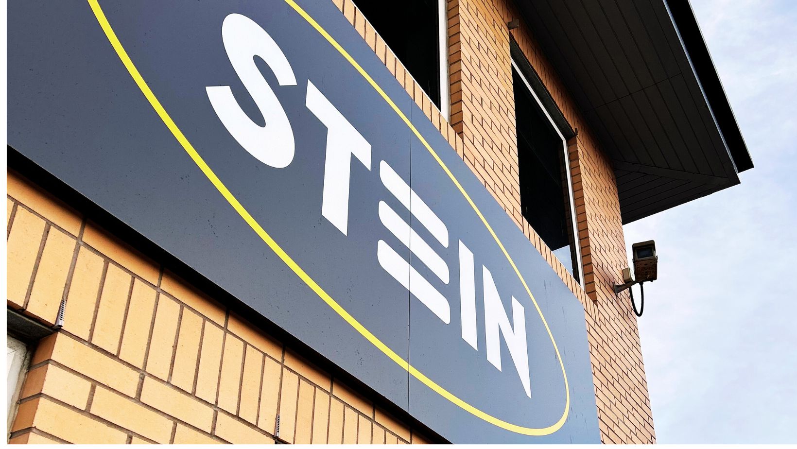 STEIN LOGO MOUNTED ONTO TO THE FRONT OF A BRICK OFFICE BUILDING