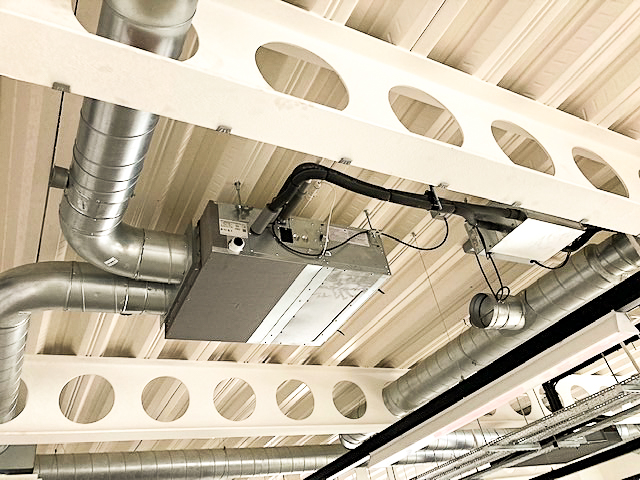 Air Conditioning Installation on ceiling inside empty office/ room includes metal pipes on ceiling